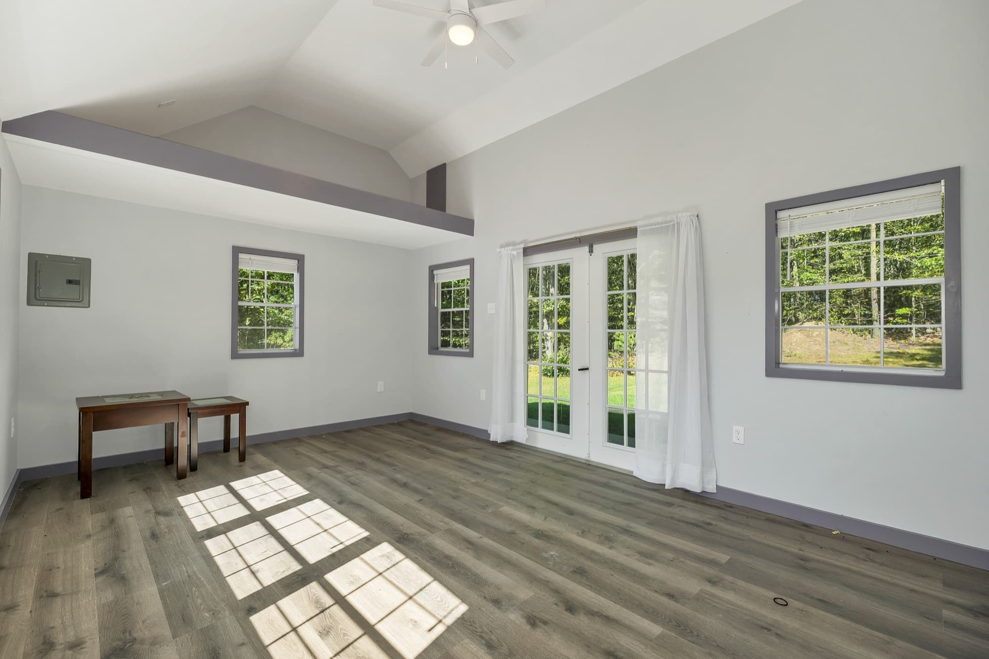 The studio's French doors and side windows, with a ceiling fan and the wood-look floor