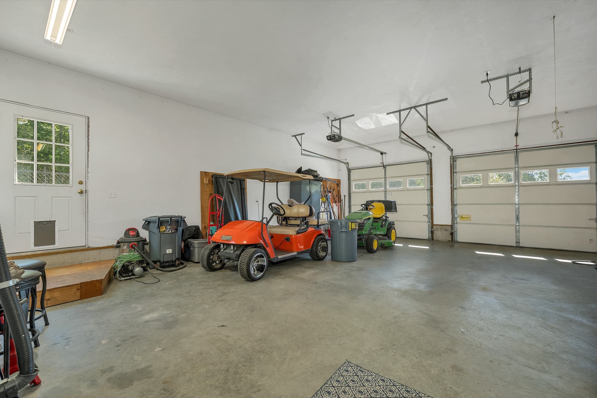 Inside the 2-car garage, with the door into the house and the 2 overhead doors